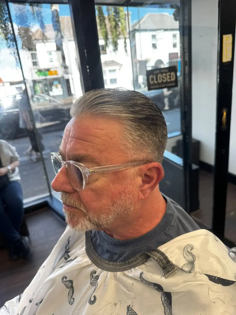 Classic grey slick-back for an older gentleman at Noah's Barber