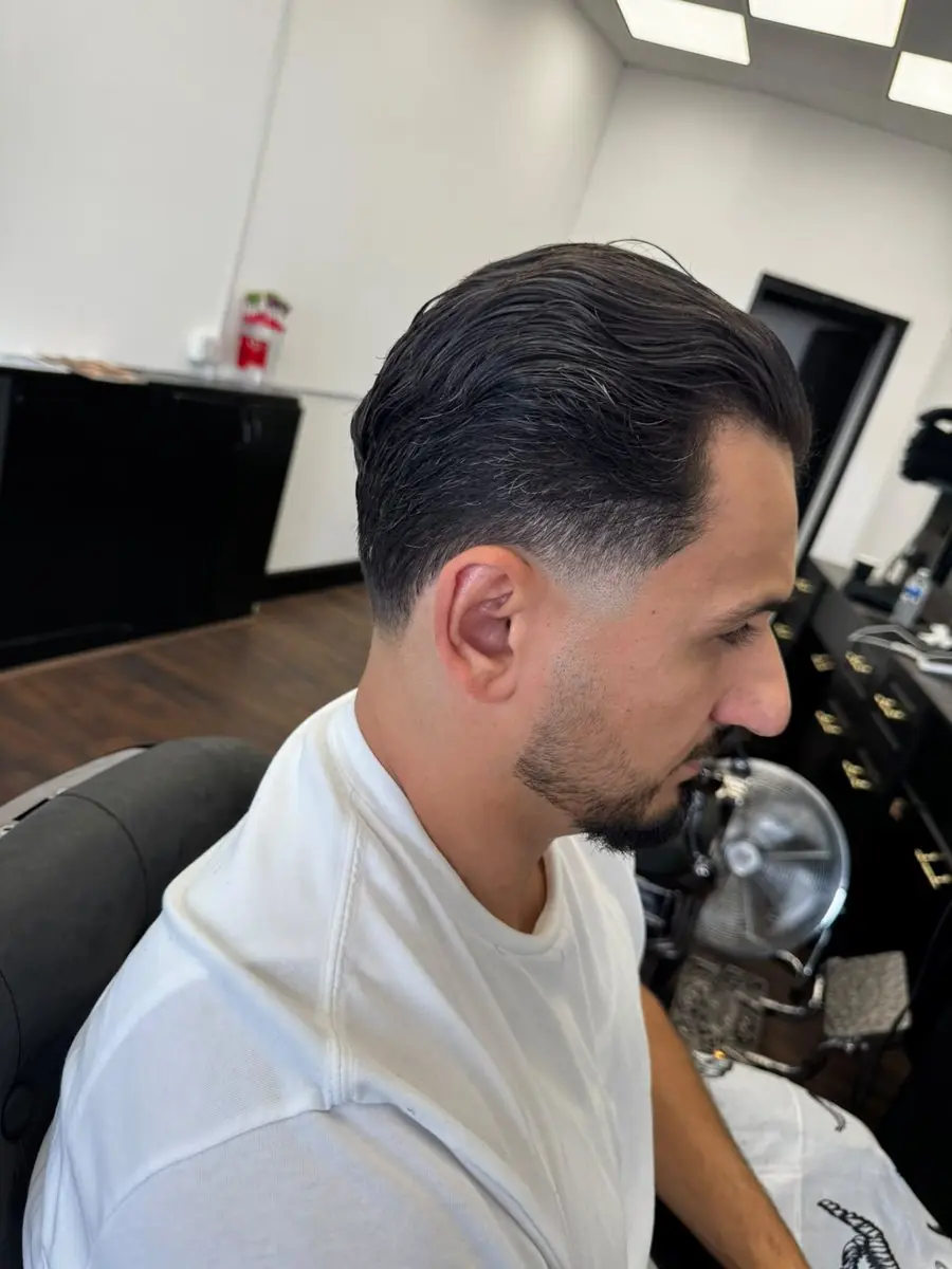 Comb-back with a mid fade cut at Noah's Barber West Wickham