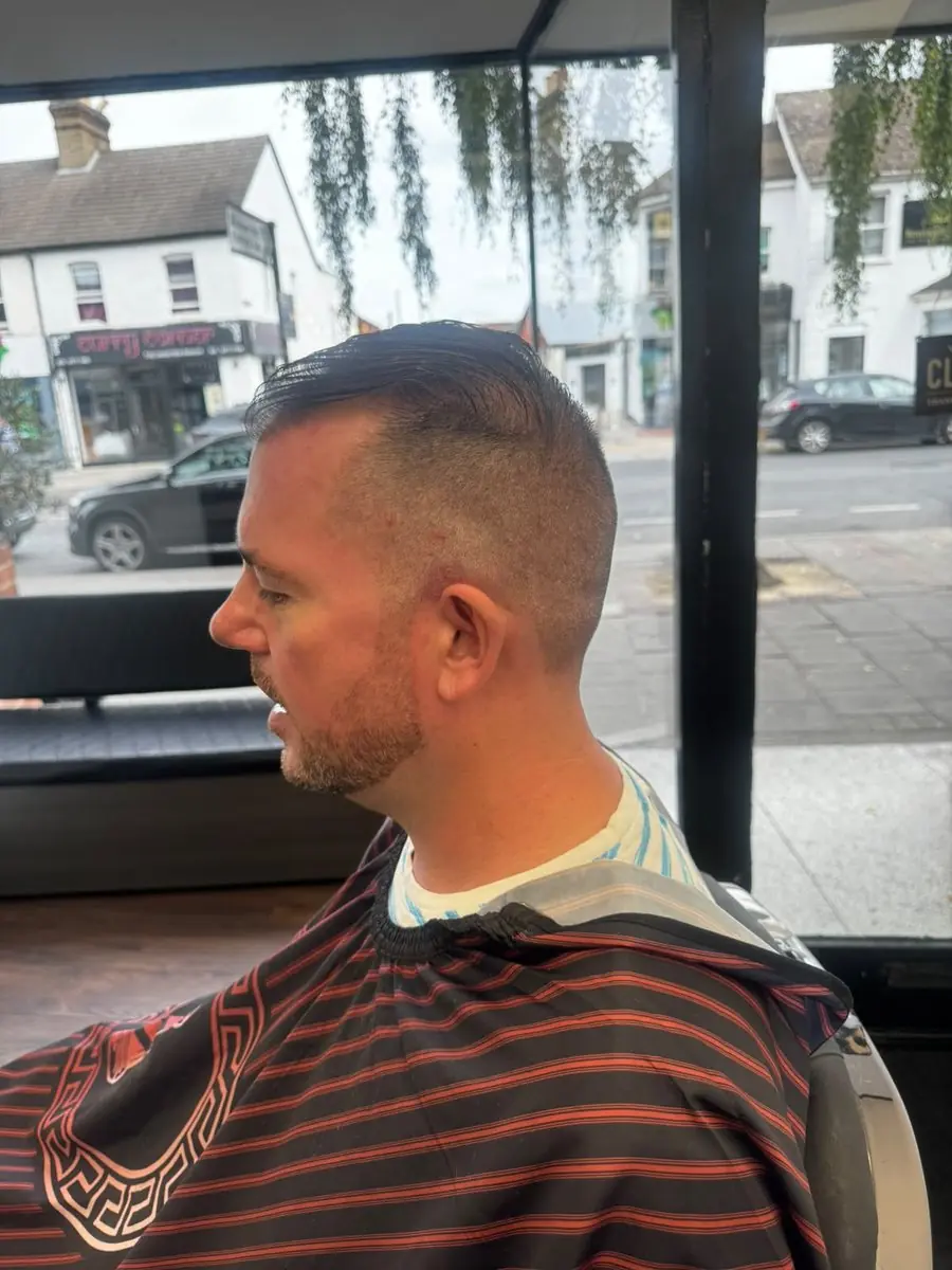 Slick-over top with a high skin fade, cut at Noah's Barber West Wickham
